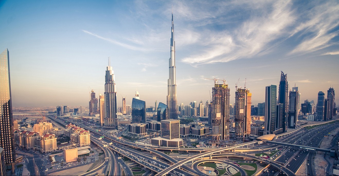 Dubai skyline at sunset with the Burj Khalifa rising above the city